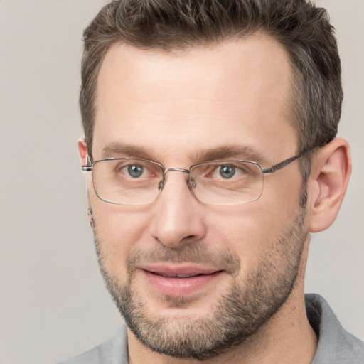 Joyful white adult male with short  brown hair and brown eyes