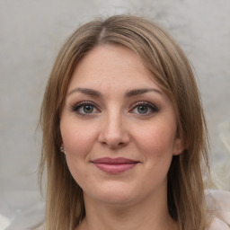 Joyful white young-adult female with medium  brown hair and grey eyes