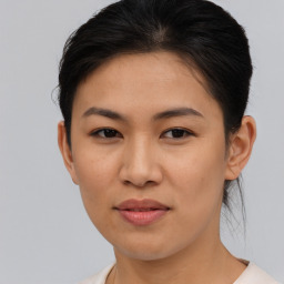 Joyful asian young-adult female with short  brown hair and brown eyes