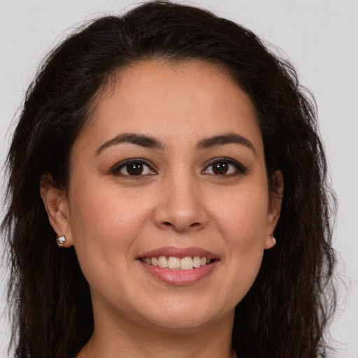 Joyful white young-adult female with long  brown hair and brown eyes