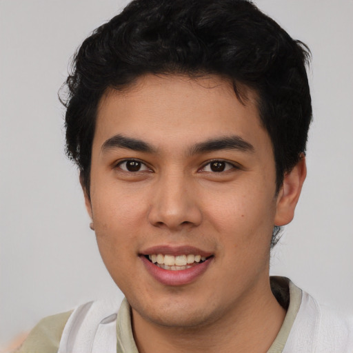 Joyful white young-adult male with short  black hair and brown eyes