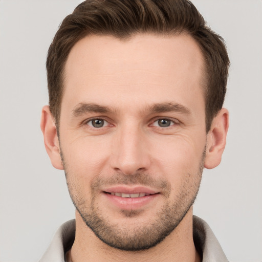 Joyful white young-adult male with short  brown hair and brown eyes