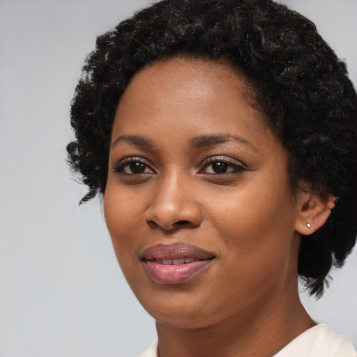 Joyful black young-adult female with medium  black hair and brown eyes
