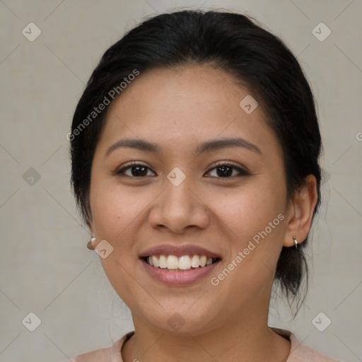 Joyful latino young-adult female with medium  brown hair and brown eyes