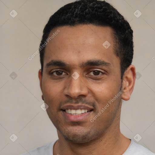 Joyful black young-adult male with short  black hair and brown eyes