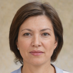 Joyful white adult female with medium  brown hair and brown eyes