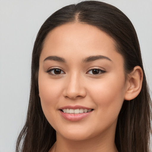 Joyful white young-adult female with long  brown hair and brown eyes