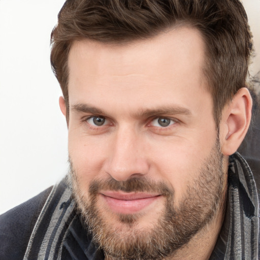 Joyful white adult male with short  brown hair and grey eyes