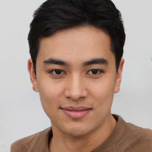 Joyful asian young-adult male with short  black hair and brown eyes
