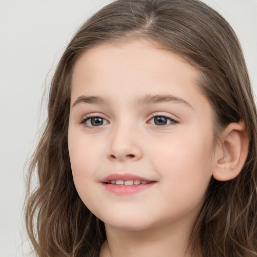 Joyful white child female with long  brown hair and brown eyes