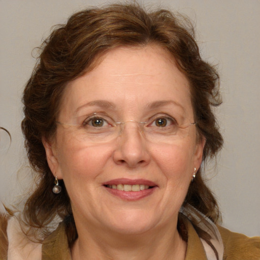 Joyful white adult female with medium  brown hair and blue eyes