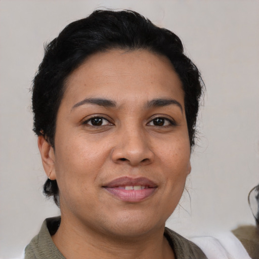 Joyful latino young-adult female with short  brown hair and brown eyes