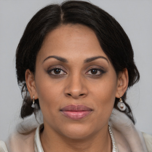 Joyful latino young-adult female with medium  brown hair and brown eyes