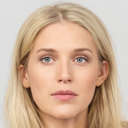 Joyful white young-adult female with long  brown hair and blue eyes