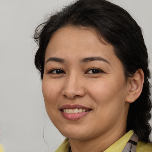 Joyful latino young-adult female with medium  brown hair and brown eyes