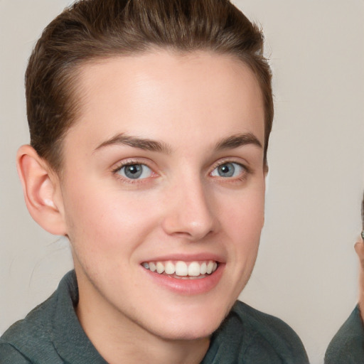 Joyful white young-adult female with short  brown hair and grey eyes