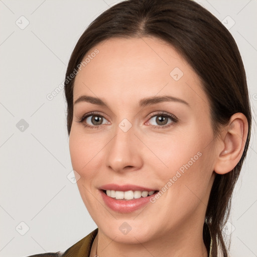 Joyful white young-adult female with long  brown hair and grey eyes