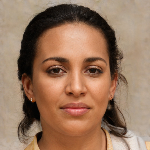 Joyful latino young-adult female with medium  brown hair and brown eyes