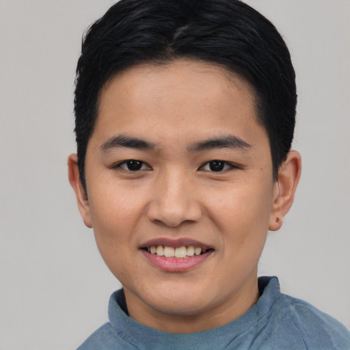 Joyful asian young-adult male with short  black hair and brown eyes