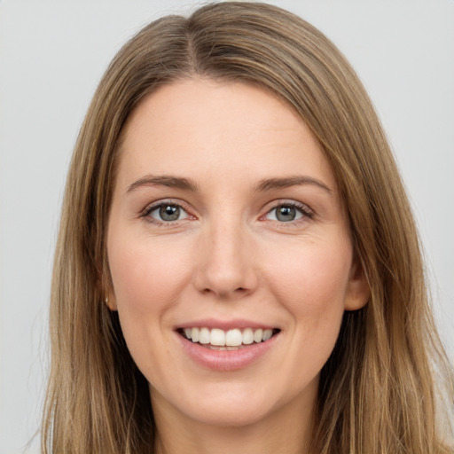 Joyful white young-adult female with long  brown hair and brown eyes