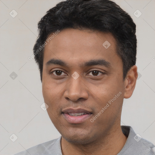 Joyful latino young-adult male with short  black hair and brown eyes