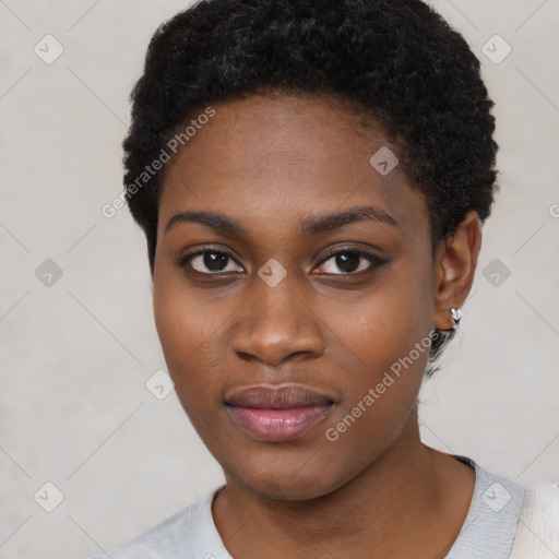 Joyful black young-adult female with short  black hair and brown eyes