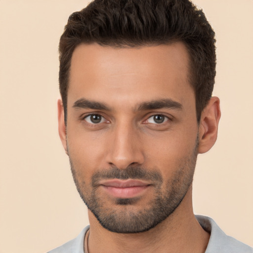 Joyful white young-adult male with short  black hair and brown eyes