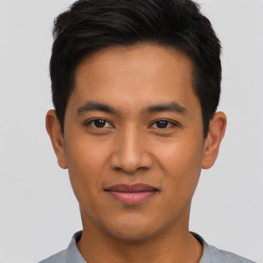 Joyful asian young-adult male with short  black hair and brown eyes