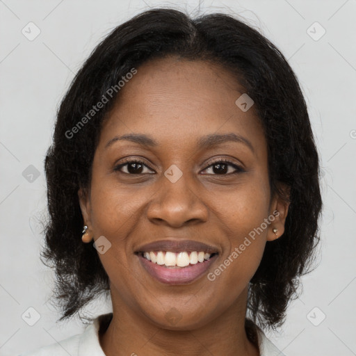 Joyful black young-adult female with long  brown hair and brown eyes