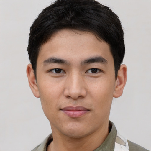 Joyful asian young-adult male with short  brown hair and brown eyes