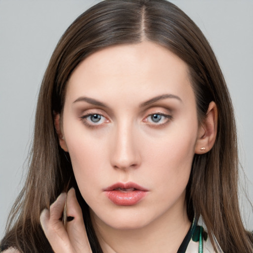 Neutral white young-adult female with long  brown hair and grey eyes