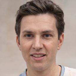 Joyful white adult male with short  brown hair and brown eyes