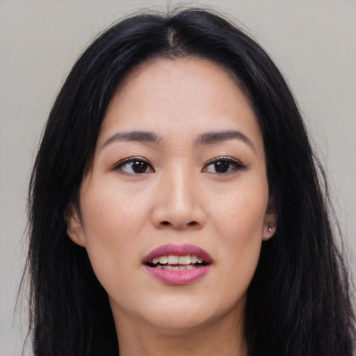 Joyful white young-adult female with long  black hair and brown eyes