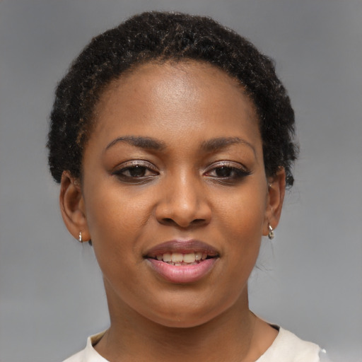 Joyful black young-adult female with short  brown hair and brown eyes
