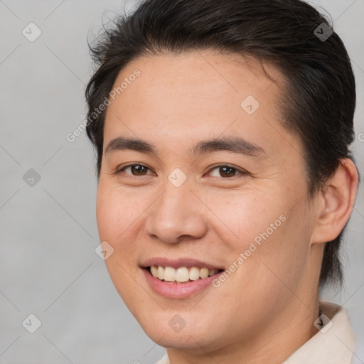 Joyful white young-adult male with short  brown hair and brown eyes