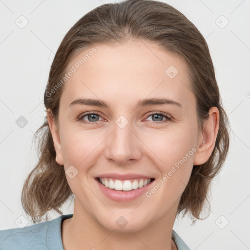 Joyful white young-adult female with medium  brown hair and grey eyes