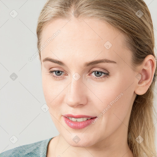 Joyful white young-adult female with medium  brown hair and blue eyes