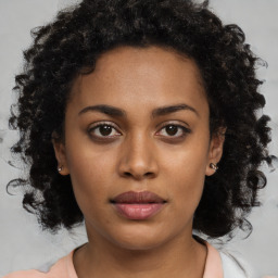 Neutral black young-adult female with medium  brown hair and brown eyes