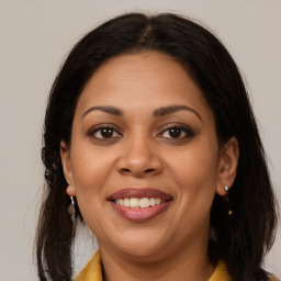 Joyful latino young-adult female with medium  brown hair and brown eyes