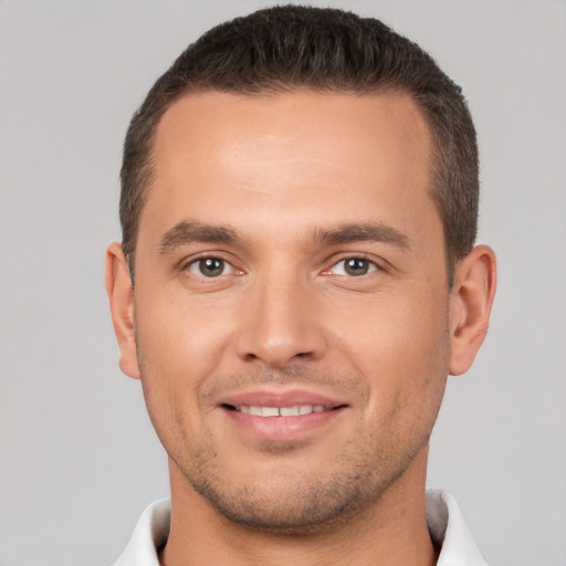 Joyful white young-adult male with short  brown hair and brown eyes