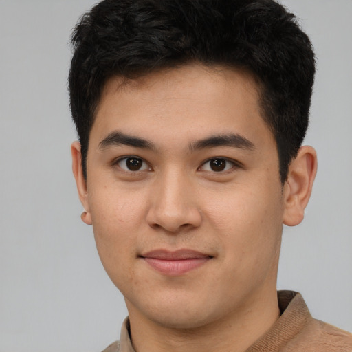 Joyful asian young-adult male with short  brown hair and brown eyes