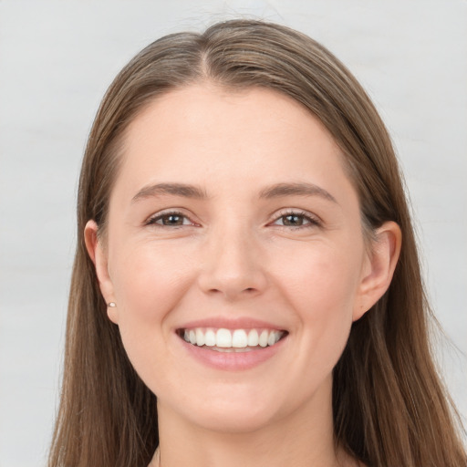 Joyful white young-adult female with long  brown hair and grey eyes