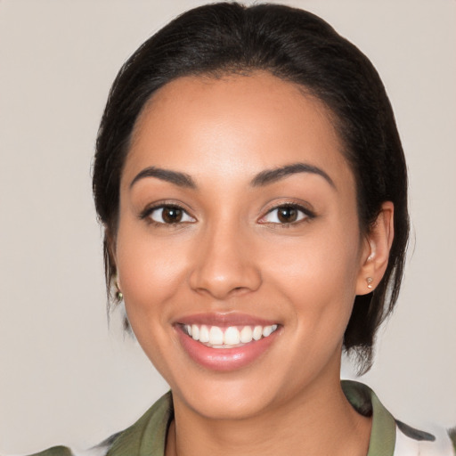 Joyful latino young-adult female with medium  black hair and brown eyes