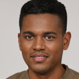 Joyful black young-adult male with short  brown hair and brown eyes