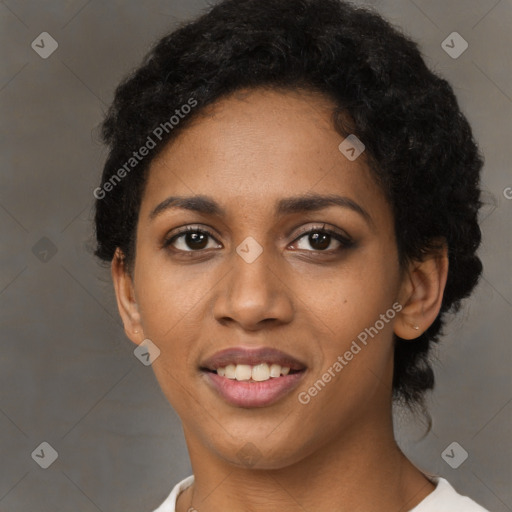 Joyful black young-adult female with short  black hair and brown eyes