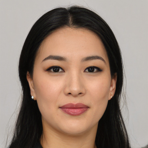Joyful asian young-adult female with long  black hair and brown eyes