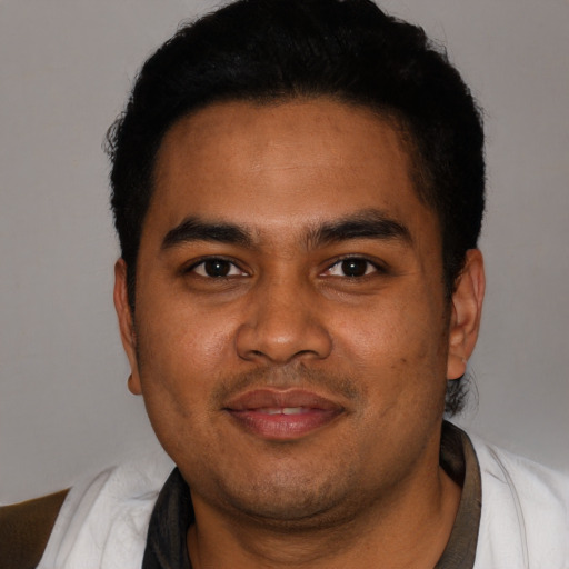 Joyful black young-adult male with short  black hair and brown eyes