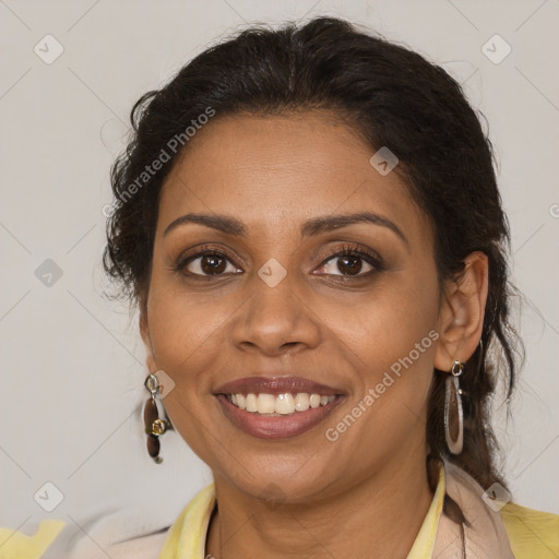 Joyful black adult female with medium  brown hair and brown eyes