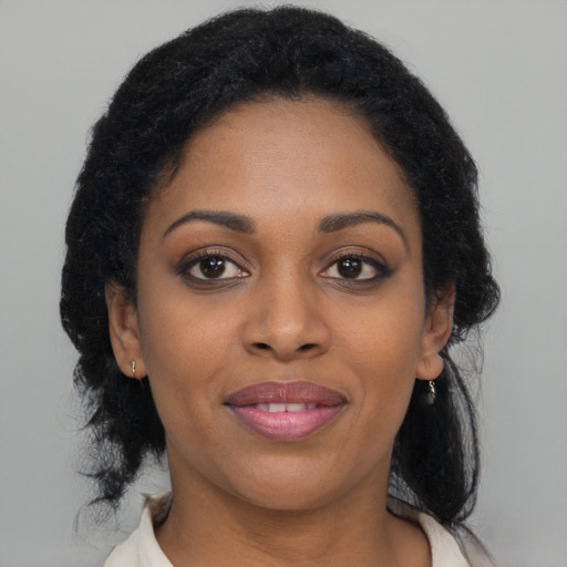 Joyful black young-adult female with medium  brown hair and brown eyes