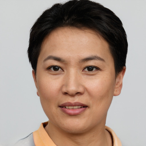 Joyful asian young-adult female with short  black hair and brown eyes